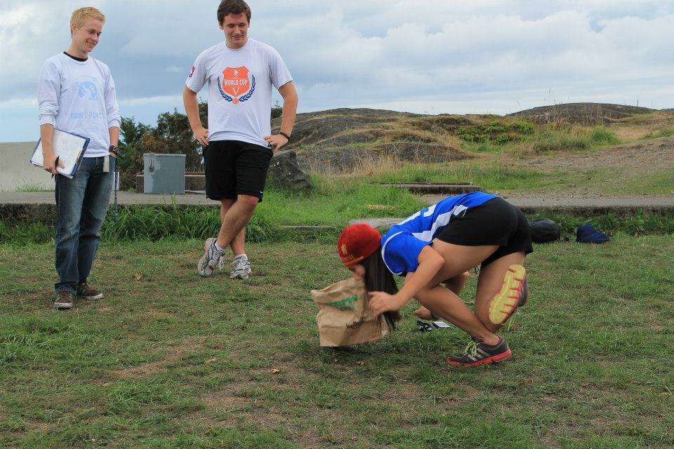 Must pick up a paper bag with your mouth. You must keep only one foot on the ground, and cannot use your hands.