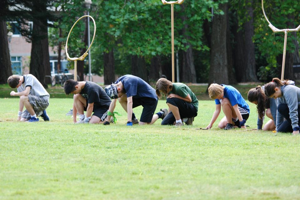 The team tensely awaits the call, "BROOMS UP!"